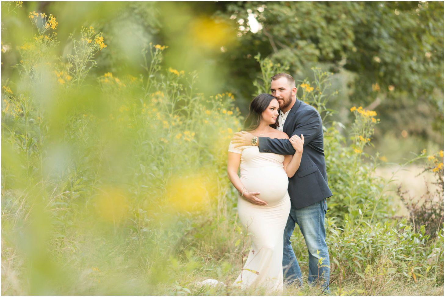 Couple in grassy field at sunset for maternity pictures at North Park in Pittsburgh