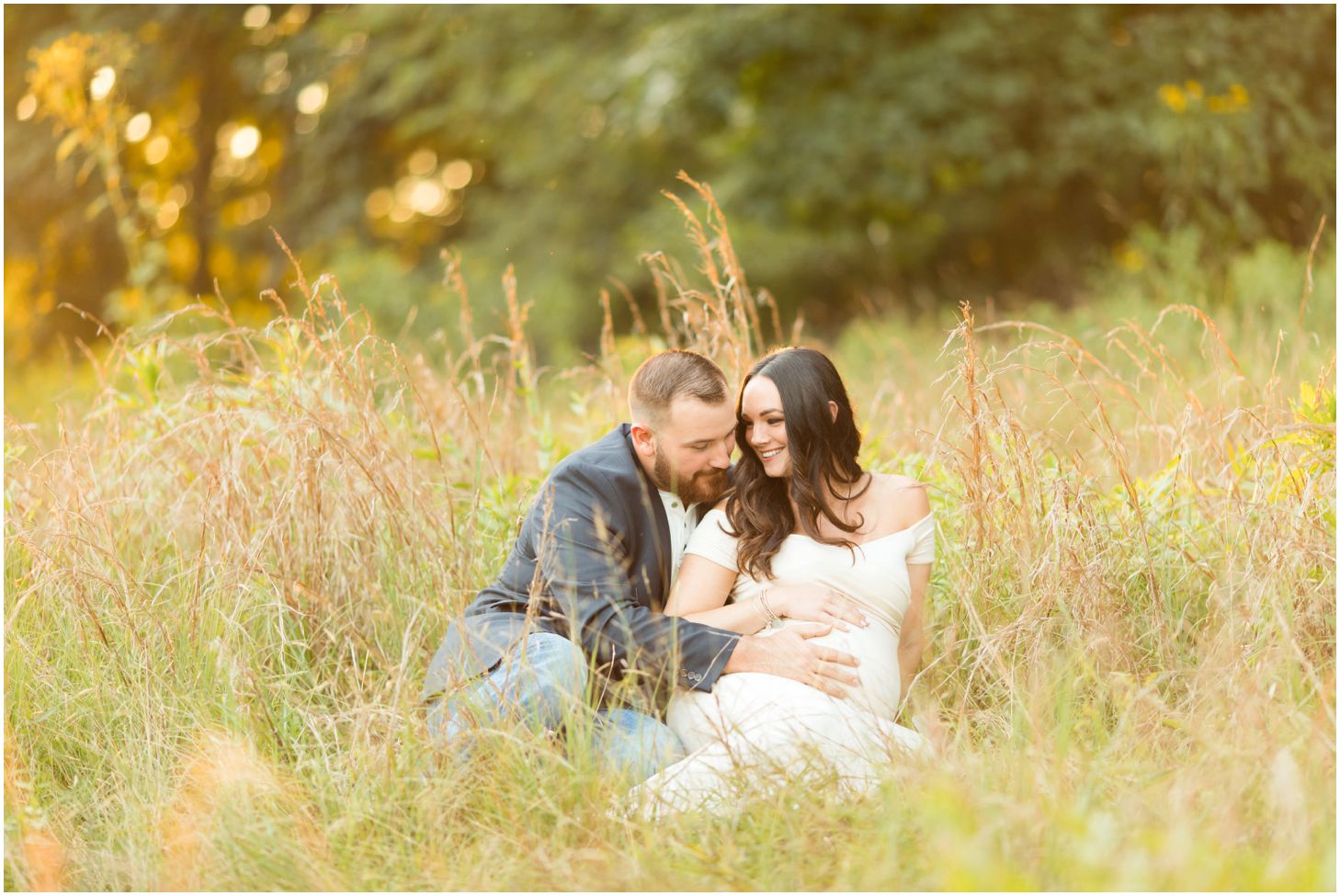 Couple in grassy field at sunset for maternity pictures at North Park in Pittsburgh