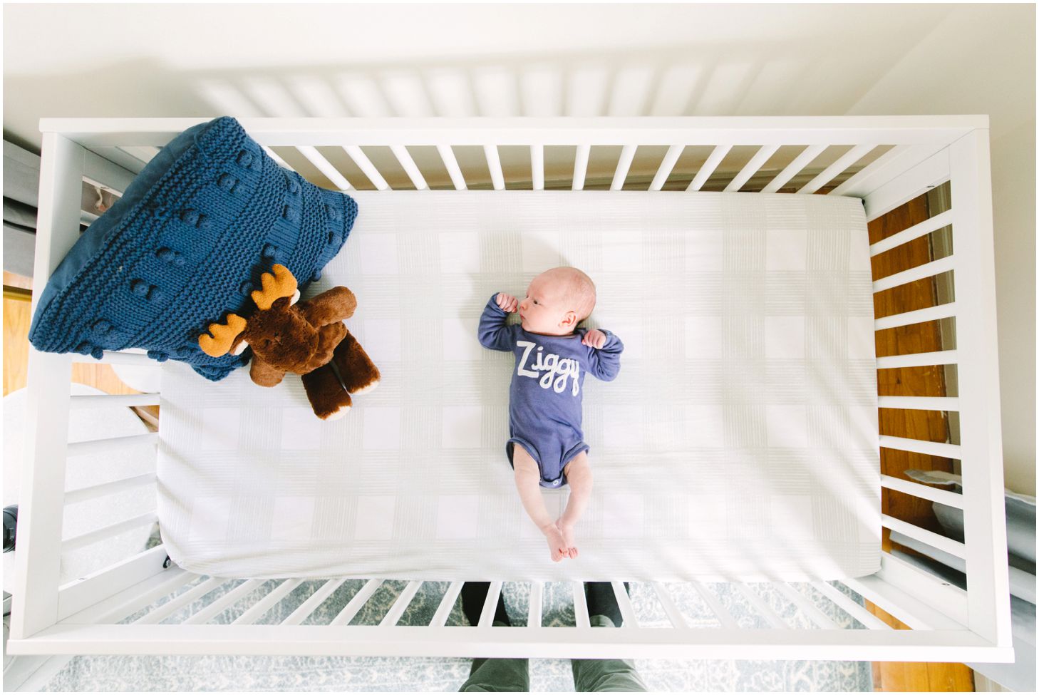 newborn lying in crib, overhead view