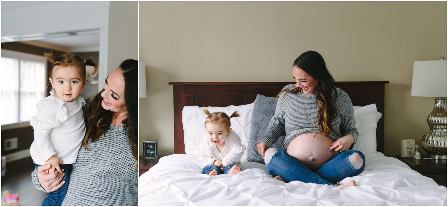 mom and little girl pose on bed together, showing their bellies
