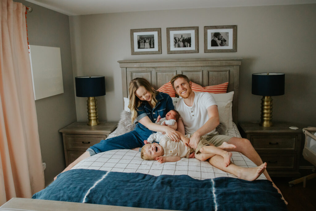 newborn family photos on bed