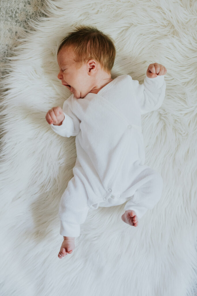 baby yawning on fur rug | Pittsburgh newborn photographer