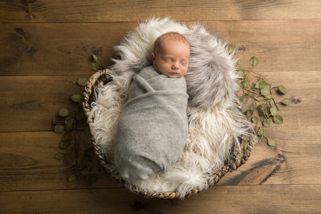 newborn baby boy with fur props | Pittsburgh newborn photography studio 