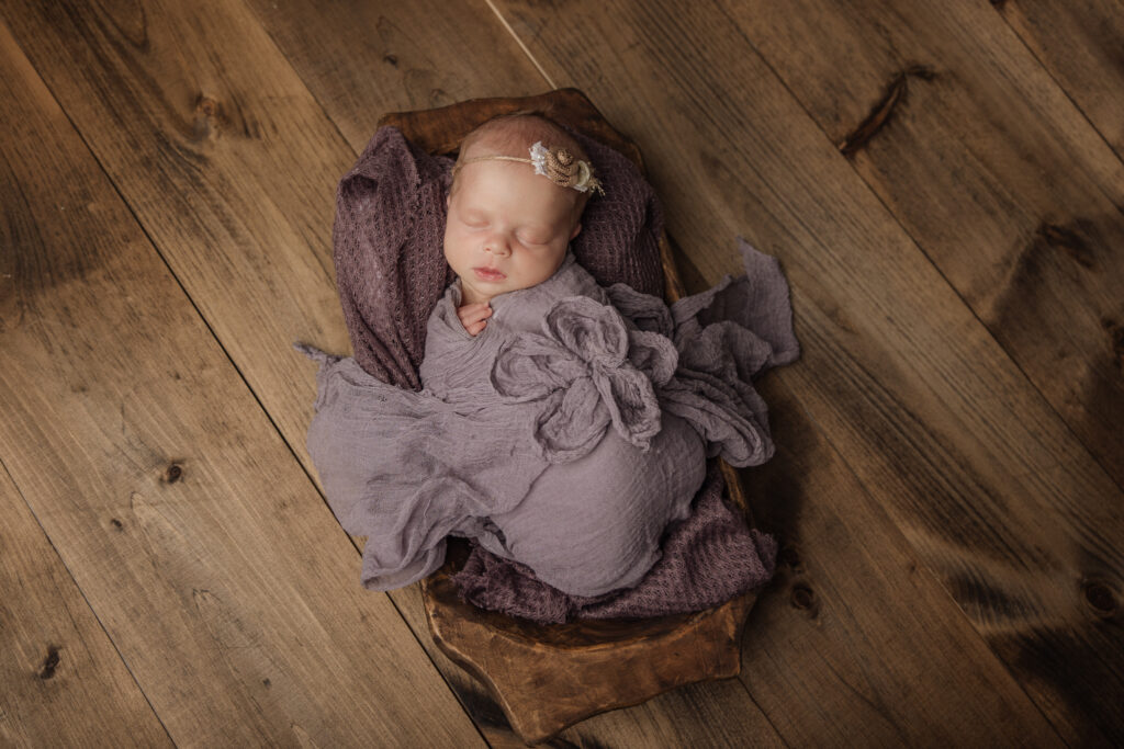 newborn girl in purple flower wrap | Pittsburgh newborn photographers Kelly Adrienne Photography