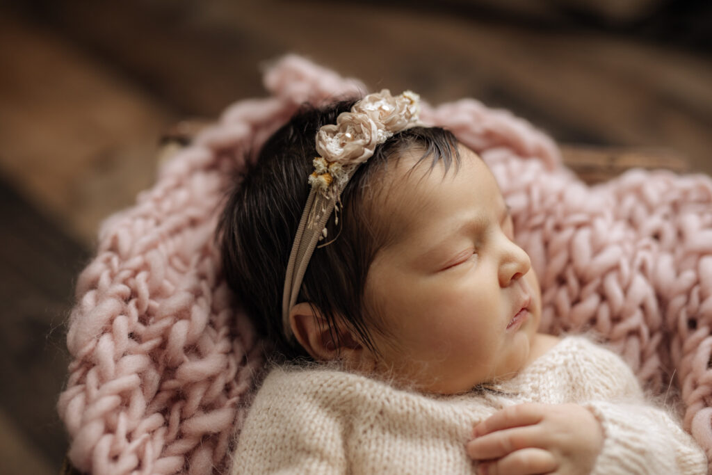 Profile of newborn girl in pink at Kelly Adrienne Photography studio