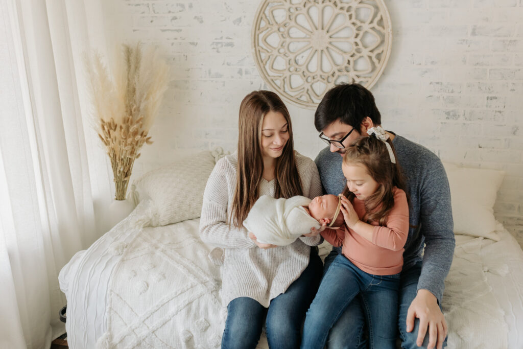 sweet family of four on bed | Kelly Adrienne photography 