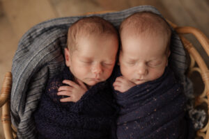 twin newborn boys in matching blue wraps, Kelly Adrienne
