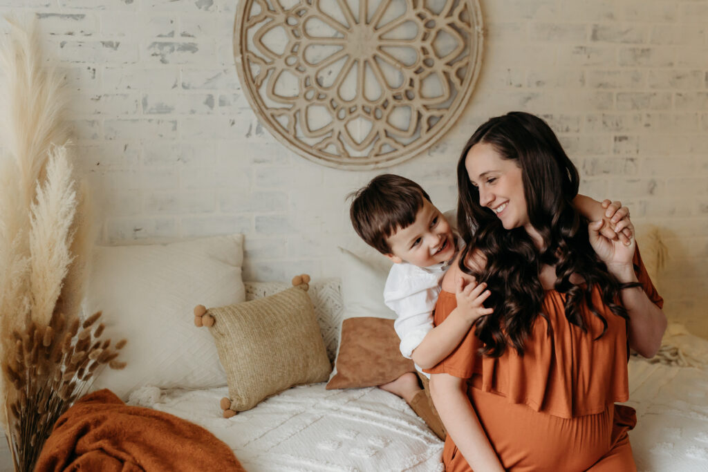 Indoor maternity session, burnt orange gown, boho, mother and son