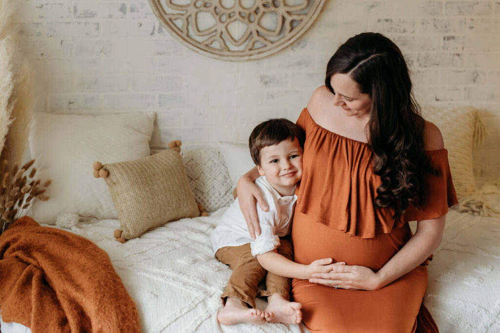 Indoor maternity session, burnt orange gown, boho, mother and son