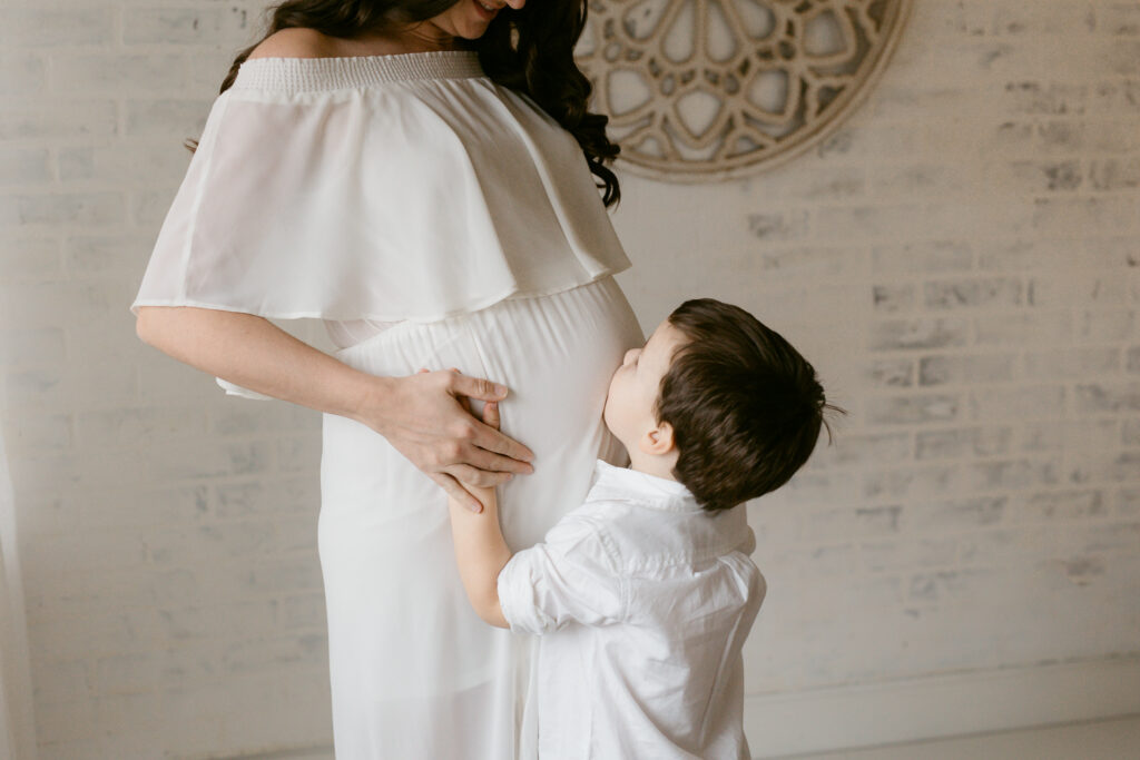 Pittsburgh studio maternity session with boy kissing mom's belly | Kelly Adrienne Photography