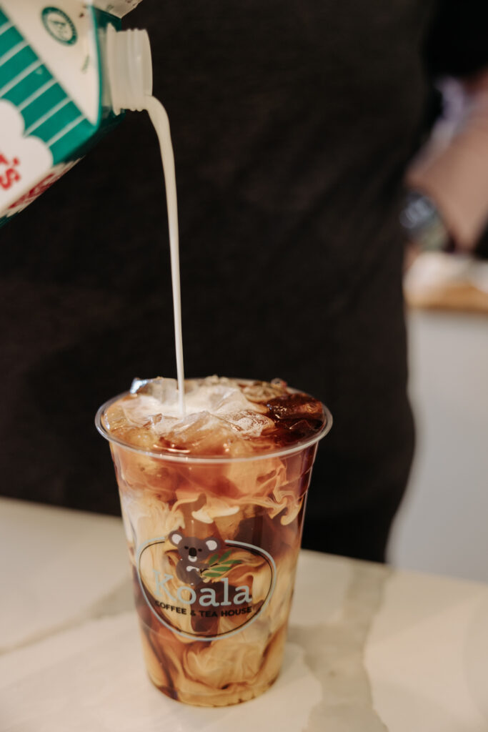 Barista pours cream into a coffee drink | Koala Cafe, Ingomar PA