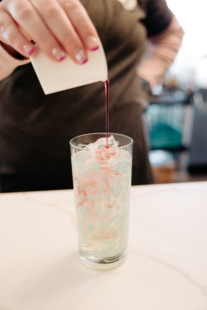 Barista pours raspberry liquid into lemonade | Koala Cafe and Tea