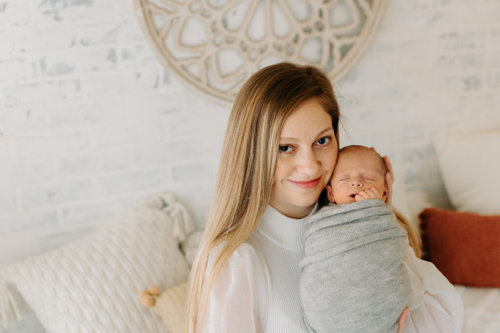 mom and baby snuggling at boho newborn session