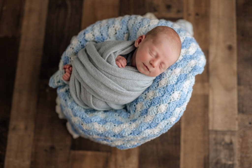 Baby lying on handmade blanket at newborn session | Kelly Adrienne Photography