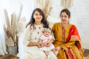 3-month old baby girl with mother and grandmother in boho studio