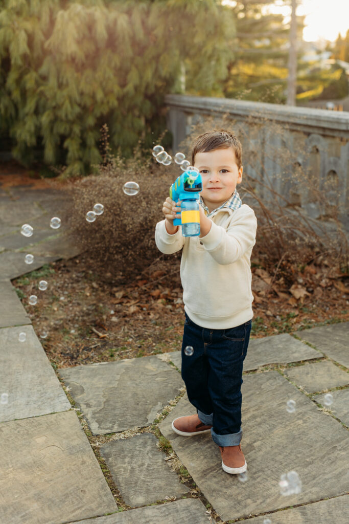Little boy blowing bubble gum at maternity photoshoot | Kelly Adrienne Photography