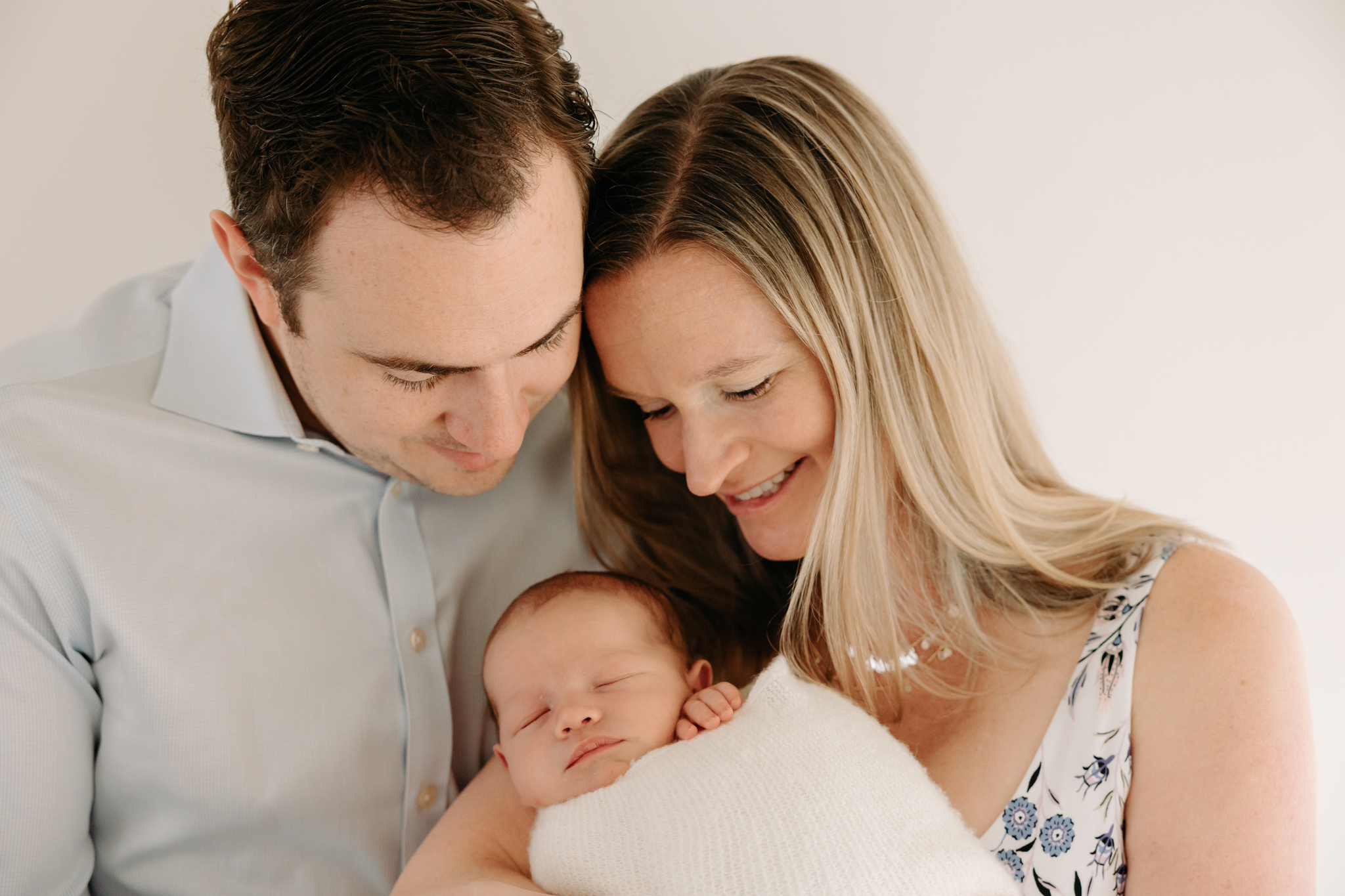 Parents and newborn at all white studio setup | Kelly Adrienne Photography