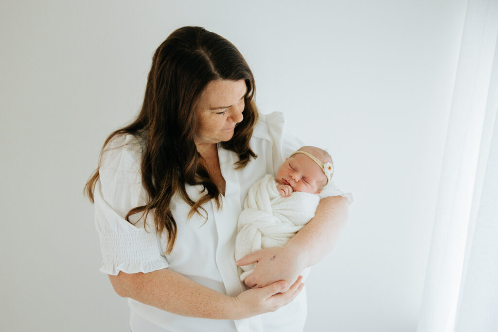 Mom holding baby girl at photography session in Wexford PA 