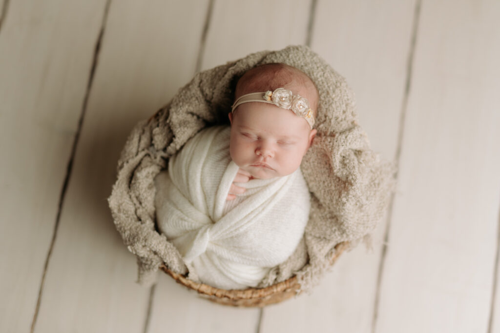 newborn wrapped in whites in a basket at newborn session in McCandless PA