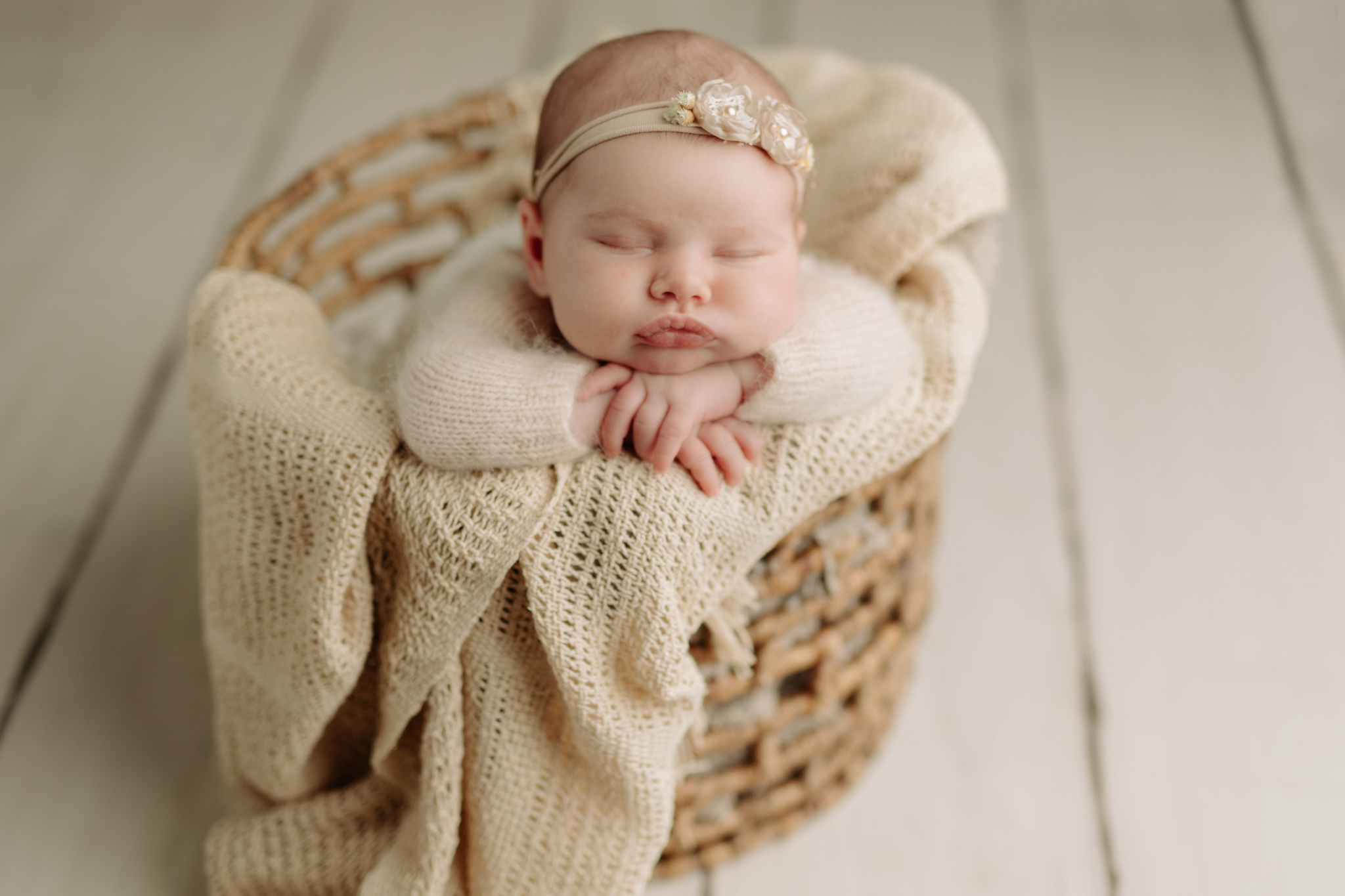 newborn wrapped in neutrals in a basket at newborn session in McCandless PA