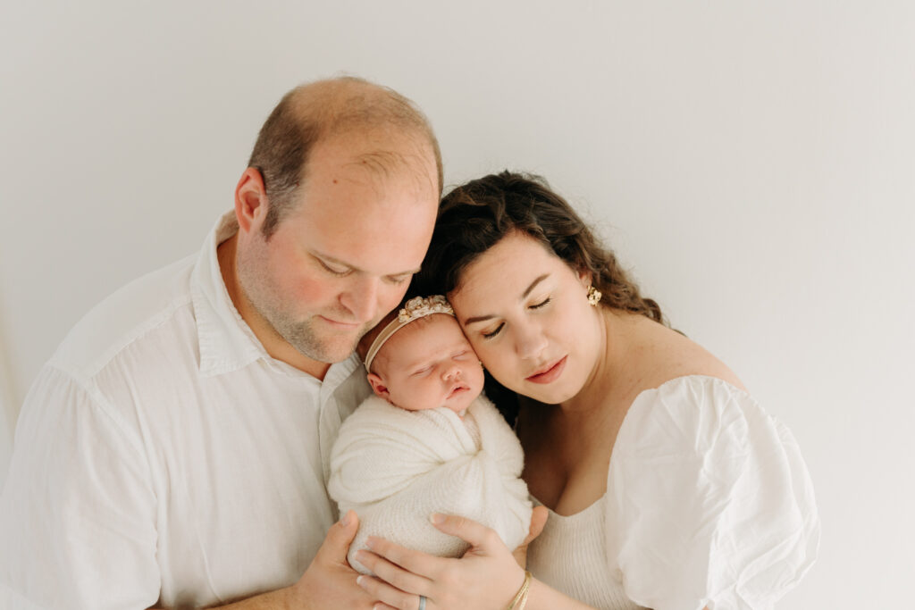Family in all white at studio newborn photos in McCandless PA