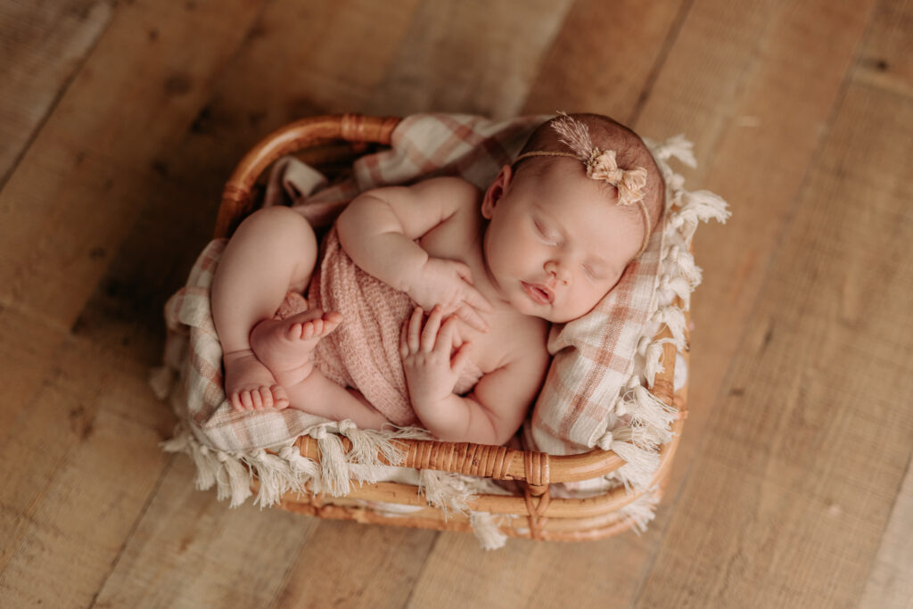 newborn girl in crate prop at Pittsburgh newborn photography studio