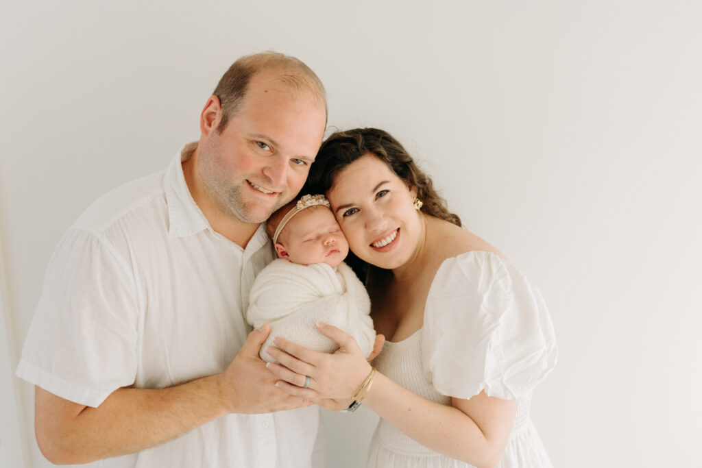 Family in all white at studio newborn photos in McCandless PA