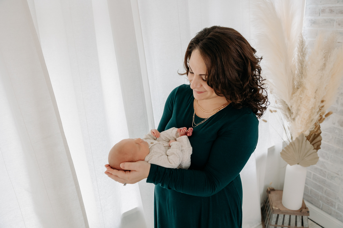 mom holding baby at Pittsburgh photo studio 