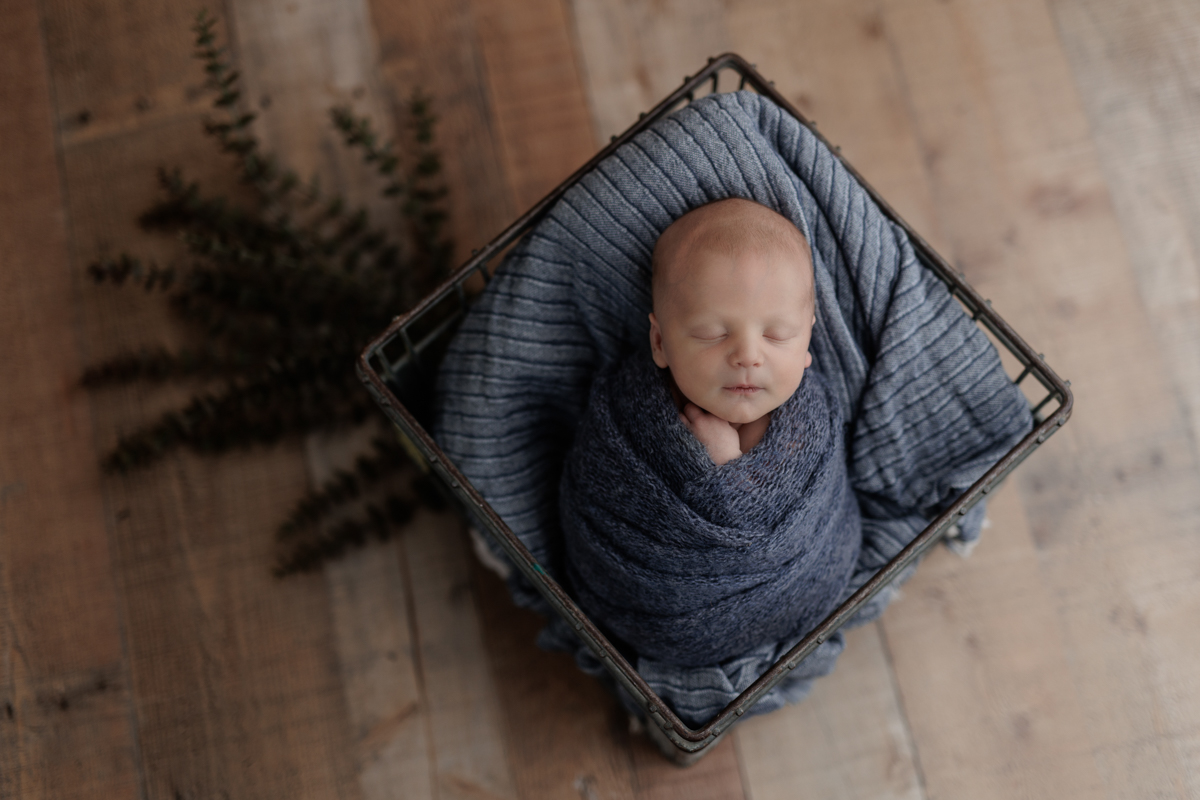 baby boy wrapped in blue at Pittsburgh newborn photo shoot
