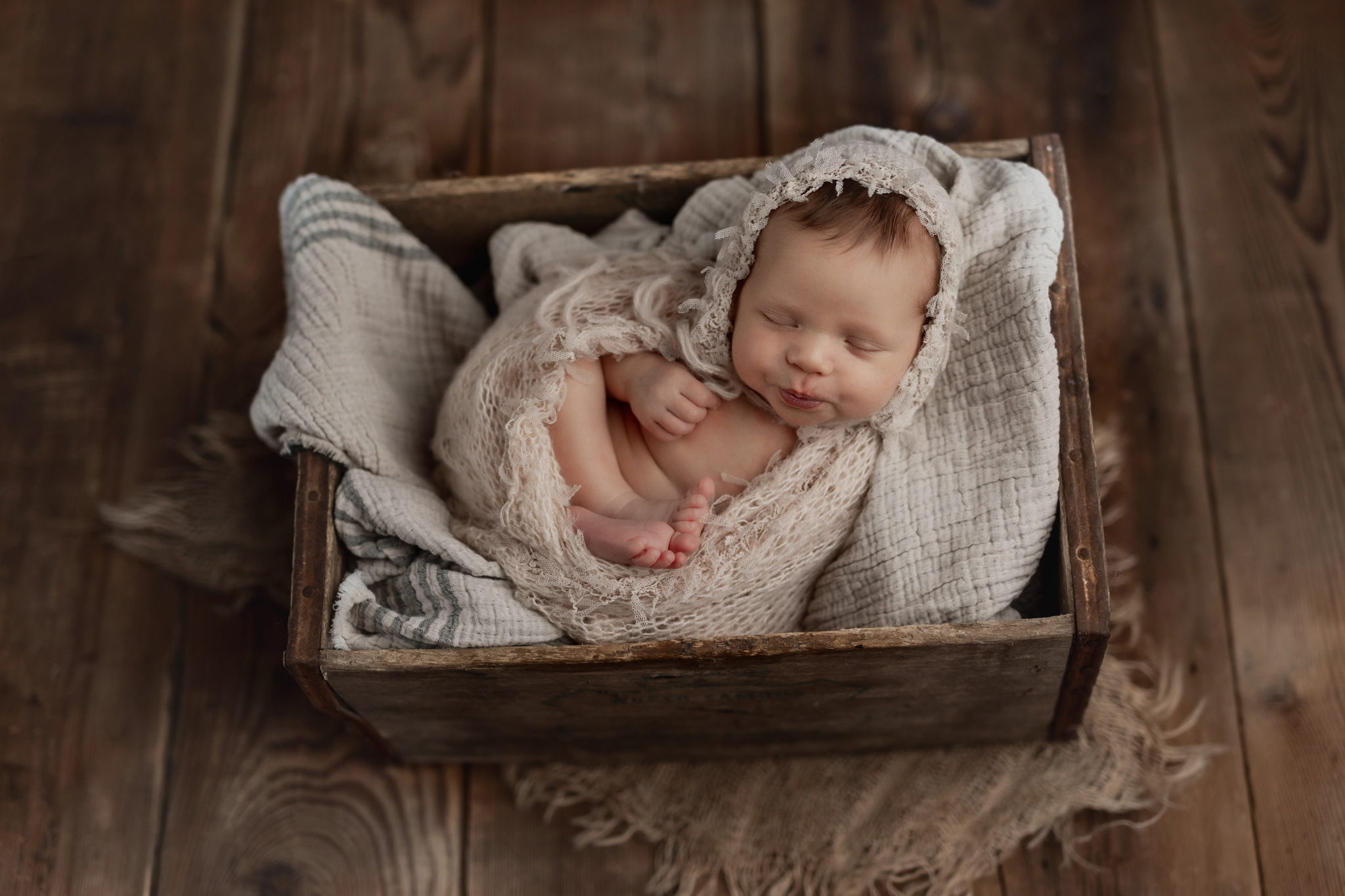 Baby girl with kissy lips at her newborn photo session 