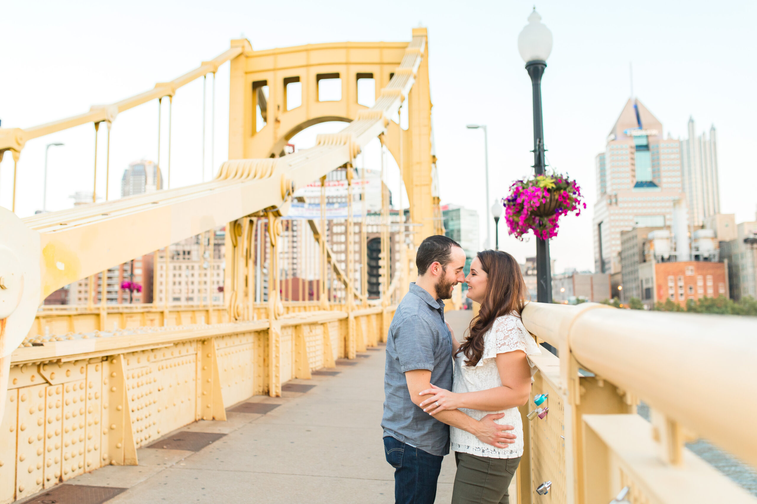 Maternity photo location in Pittsburgh North Shore, featuring a couple on a yellow bridge.