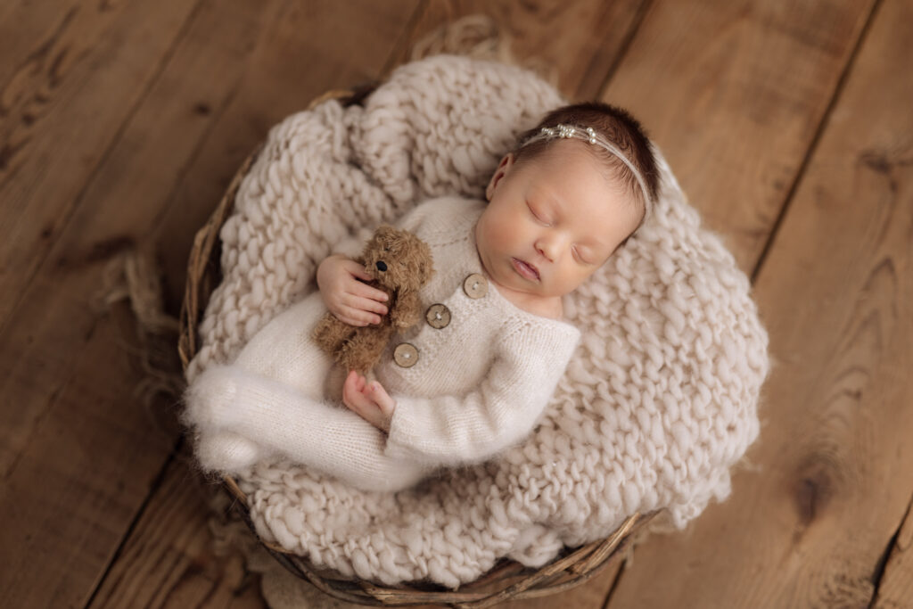 newborn girl in white cuddling teddy bear | Pittsburgh studio