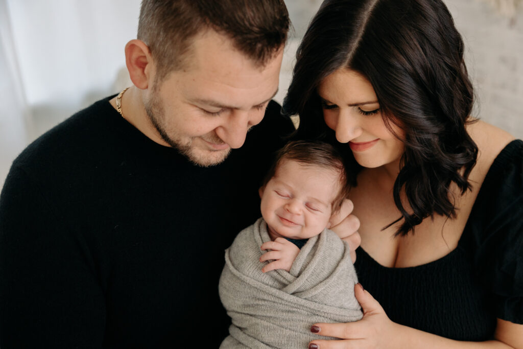 close-up of mom, dad, and baby at their newborn session 