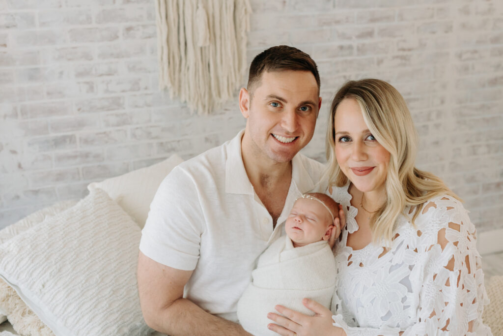 Beautiful white photo studio and family in white at their newborn session