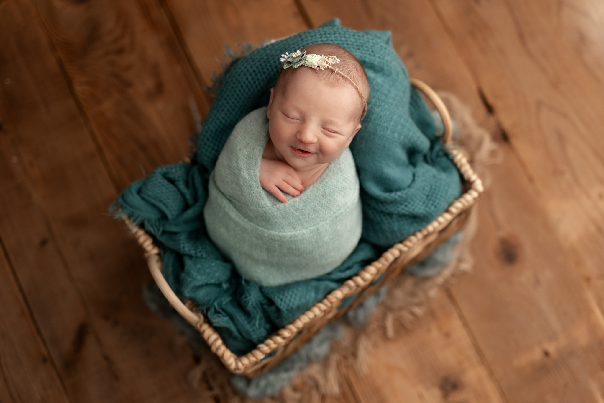 smiling baby girl in blues at her newborn photos in Pittsburgh 