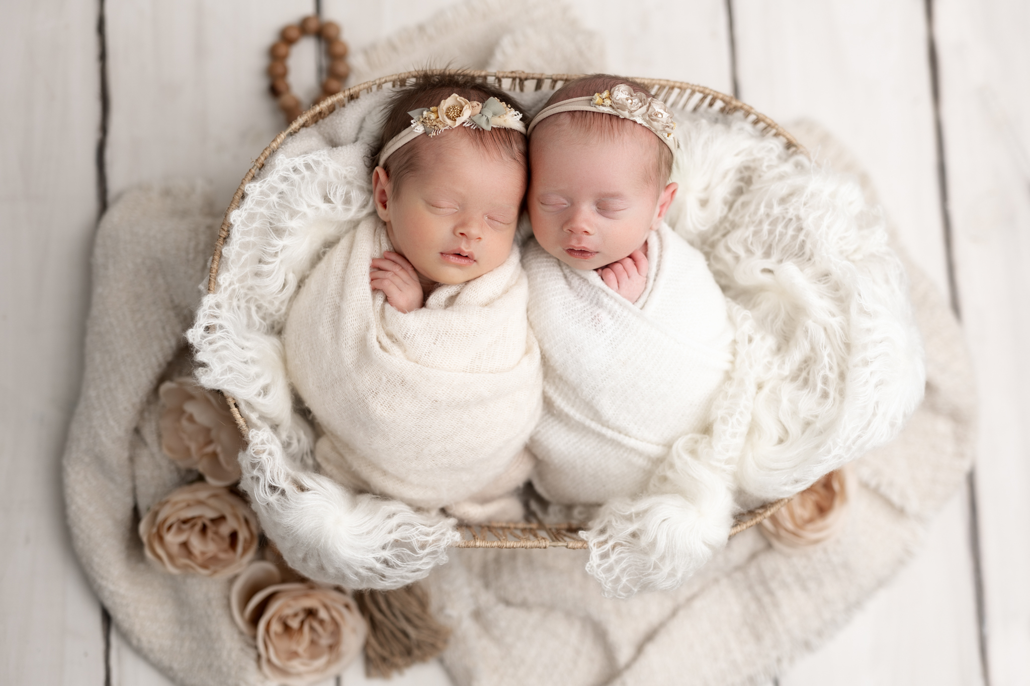 newborn twins in white setup at photo shoot